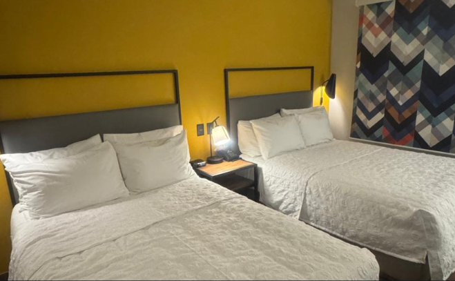 Two beds in a Tru by Hilton guest room